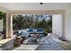 The covered patio features a stylish blue sectional sofa, area rug, and view of the backyard at 9192 Bradleigh Dr, Winter Garden, FL 34787