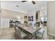 Open dining area features a gray table with seating for six, a light fixture, and wood-look flooring at 9192 Bradleigh Dr, Winter Garden, FL 34787