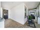 Inviting front porch with rocking chairs, a gray door, and brick pavers, perfect for relaxing outdoors at 9192 Bradleigh Dr, Winter Garden, FL 34787