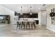 Modern kitchen with stainless steel appliances, dark cabinets, a center island, and pendant lighting at 9192 Bradleigh Dr, Winter Garden, FL 34787