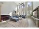 Spacious living room with high ceilings, lots of natural light, a blue sectional, and a grand piano at 9192 Bradleigh Dr, Winter Garden, FL 34787