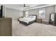 Spacious main bedroom with neutral colors, a tray ceiling, carpeting, and lots of natural light at 9192 Bradleigh Dr, Winter Garden, FL 34787