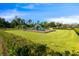 Community playground with green slides and swings, nestled within a well-maintained grassy area at 9192 Bradleigh Dr, Winter Garden, FL 34787