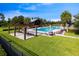 Sparkling community pool surrounded by lush landscaping, lounge chairs, and a covered pavilion at 9192 Bradleigh Dr, Winter Garden, FL 34787