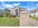 Charming two-story home featuring a well-manicured lawn and an attached two-car garage at 9227 Pecky Cypress Way, Orlando, FL 32836