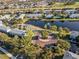 Aerial view showcasing the community's entrance, fountain pond, and landscaped roundabout at 10731 Savannah Wood Dr # 209, Orlando, FL 32832