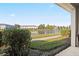 Scenic view of the pond from the condo's patio with lush greenery at 10731 Savannah Wood Dr # 209, Orlando, FL 32832