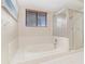 Bathroom featuring a white tub with tile surround and a glass-enclosed shower at 122 Spring Chase Cir, Altamonte Springs, FL 32714