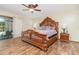 Main bedroom showcasing a large wood bed frame, ceiling fan, and sliding door access at 122 Spring Chase Cir, Altamonte Springs, FL 32714