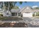 Charming single Gathering home featuring a two-car garage and lovely neutral-colored siding at 12401 Harney Dr, Orlando, FL 32828