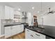 Stylish kitchen with island, white cabinets, and stainless steel hood at 12401 Harney Dr, Orlando, FL 32828