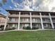 Spacious condo building showing lush lawn and manicured shrubbery at 125 Water Front Way # 200, Altamonte Springs, FL 32701