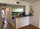 Open-concept kitchen with a breakfast bar and a view into a bedroom at 125 Water Front Way # 200, Altamonte Springs, FL 32701