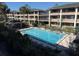 Exterior view of a well-maintained community pool surrounded by lush landscaping at 125 Water Front Way # 200, Altamonte Springs, FL 32701