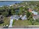 An aerial view showing the property's location near a waterway, with mature trees and lush landscaping at 1300 Conrad Dr, New Smyrna Beach, FL 32168