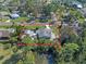 Aerial view shows the property's boundaries and location amidst lush trees and a pond nearby at 1300 Conrad Dr, New Smyrna Beach, FL 32168