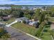 Aerial view of single-Gathering home with green lawns and a long driveway near the water at 1300 Conrad Dr, New Smyrna Beach, FL 32168