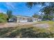 Home exterior with a large gravel area and sparse landscaping surrounding the back of the house at 1300 Conrad Dr, New Smyrna Beach, FL 32168