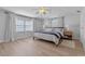 Serene bedroom featuring hardwood floors, natural light, and stylish decor at 1300 Conrad Dr, New Smyrna Beach, FL 32168