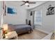 Bedroom featuring a ceiling fan, natural light, a bed, and laminate wood flooring at 1300 Conrad Dr, New Smyrna Beach, FL 32168