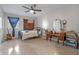 Bedroom featuring a ceiling fan, eclectic decor, and plenty of space at 1300 Conrad Dr, New Smyrna Beach, FL 32168