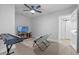 Bonus room including a keyboard, tv, chair, and a view to another room at 1300 Conrad Dr, New Smyrna Beach, FL 32168