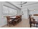 Well-lit dining area with a large window and adjacent kitchen island seating at 1300 Conrad Dr, New Smyrna Beach, FL 32168