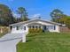 Charming single-story home featuring a well-maintained lawn and blue shutters at 1300 Conrad Dr, New Smyrna Beach, FL 32168