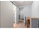 Hallway including a bathroom and a door with a wooden desk near the corner at 1300 Conrad Dr, New Smyrna Beach, FL 32168