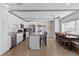 Open concept kitchen with stainless steel appliances, island, and adjacent dining area at 1300 Conrad Dr, New Smyrna Beach, FL 32168