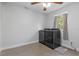 Modern laundry room showcasing a dark washer and dryer with a ceiling fan and a window at 1300 Conrad Dr, New Smyrna Beach, FL 32168