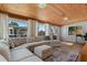 Bright sunroom featuring wood ceilings, large windows, and a comfortable sectional sofa at 1300 Conrad Dr, New Smyrna Beach, FL 32168