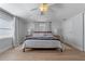 Bright main bedroom featuring a ceiling fan, wood floor, and bedside lamps at 1300 Conrad Dr, New Smyrna Beach, FL 32168