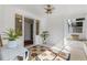 Inviting sunroom featuring tile flooring, a ceiling fan, and bright sunlight at 1300 Conrad Dr, New Smyrna Beach, FL 32168