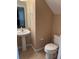 A small, bright bathroom with a pedestal sink and toilet at 1515 Angler Ave, Kissimmee, FL 34746