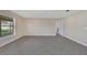 Neutral bedroom with a large window, tile flooring and view to the attached bathroom at 1515 Angler Ave, Kissimmee, FL 34746