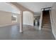 Open-concept foyer with tile flooring, staircase to the second floor and an arched entryway at 1515 Angler Ave, Kissimmee, FL 34746