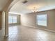 Open living room featuring tile flooring, neutral paint, an archway, and a decorative chandelier at 1515 Angler Ave, Kissimmee, FL 34746