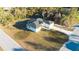 Aerial view of a new construction home featuring a modern design and a well-manicured lawn at 15215 Sw 43Rd Ct, Ocala, FL 34473