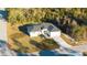 Aerial view of a new construction home featuring a modern design and a well-manicured lawn at 15215 Sw 43Rd Ct, Ocala, FL 34473