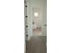 Hallway view of a bathroom with a freestanding tub and neutral decor at 15215 Sw 43Rd Ct, Ocala, FL 34473