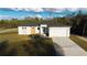 New construction home featuring a modern design, two-car garage and a well-manicured lawn at 15215 Sw 43Rd Ct, Ocala, FL 34473