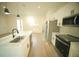 Modern kitchen with stainless steel appliances and a white island with a sink and dishwasher at 15215 Sw 43Rd Ct, Ocala, FL 34473