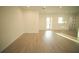 Spacious living room with light hardwood floors, a door to the exterior, and one window at 15215 Sw 43Rd Ct, Ocala, FL 34473