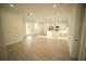 Open-concept living room and kitchen area features light wood floors and natural light at 15215 Sw 43Rd Ct, Ocala, FL 34473