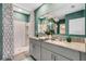 Bathroom showcasing double vanity, granite countertop, a large mirror, and a shower with white and gray curtain at 1705 Three Bars Rd, Kissimmee, FL 34744