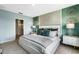 A primary bedroom features green accent wall and a large bed with decorative pillows and gray blanket at 1705 Three Bars Rd, Kissimmee, FL 34744
