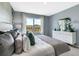 A light and bright bedroom showcasing a large window, dresser, and a plush bed with decorative pillows at 1705 Three Bars Rd, Kissimmee, FL 34744