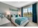Comfortable bedroom with teal accents, bedside tables, and a large window at 1705 Three Bars Rd, Kissimmee, FL 34744