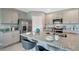 Modern kitchen featuring stainless steel appliances and a large granite countertop island at 1705 Three Bars Rd, Kissimmee, FL 34744
